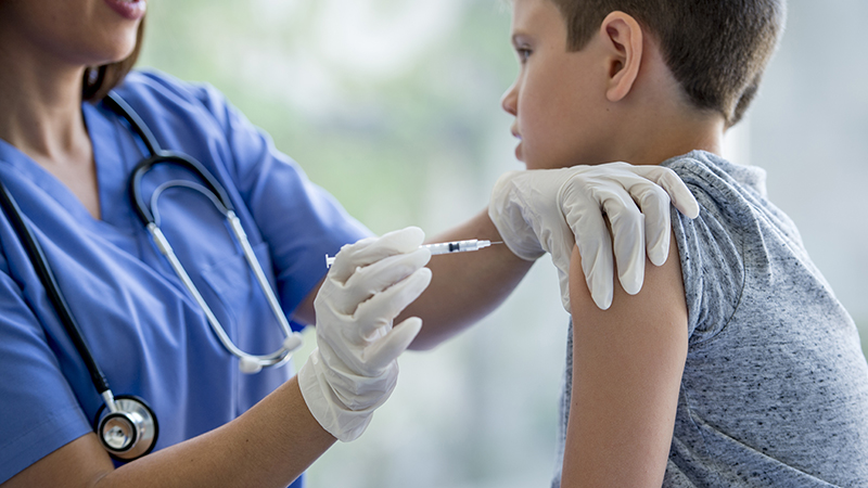 young boy getting an injection in his arm