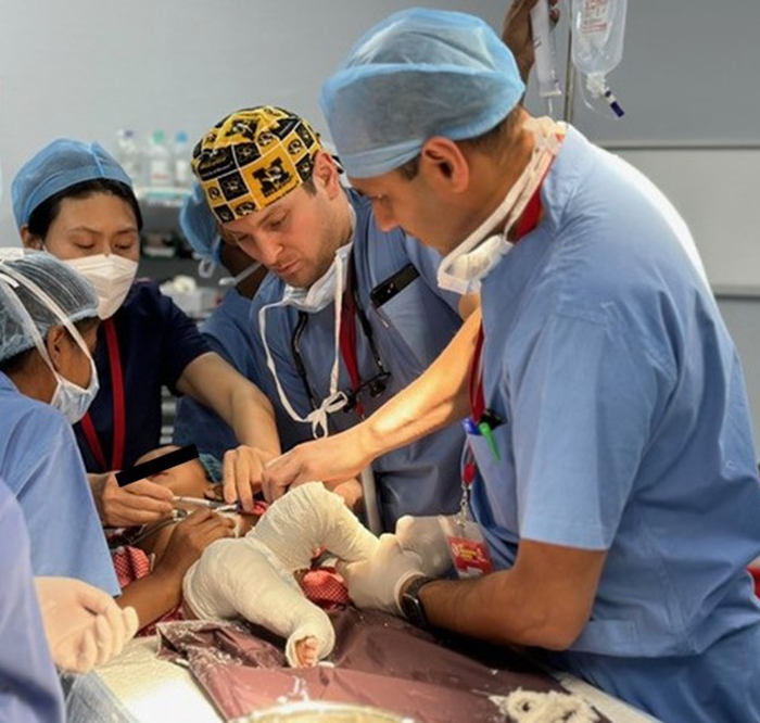 Dr. Resnick and Dr. Gupta apply clubfoot casts in the OR during a mission trip to India.