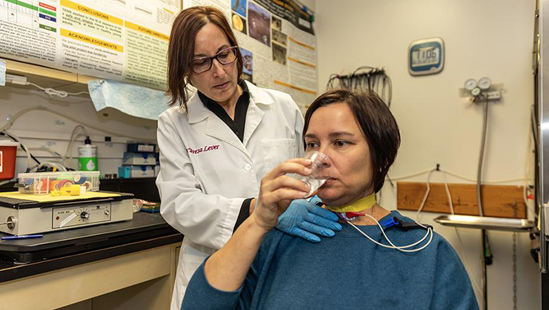 Teresa Lever, left, tests a healthy volunteer's swallowing function in one of her studies. 