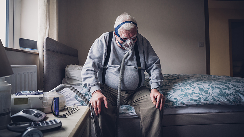 Elderly Man with Medical Breathing Apparatus