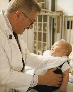 Ted Groshong holding infant