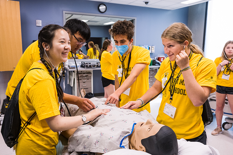 High school mini med campers in the simulation center during camp. 
