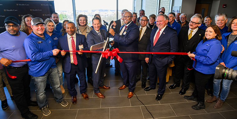 MU Health Care CEO Ric Ransom and Capital Region COO Denny Hamilton cut the ceremonial ribbon signifying the integration of Capital Region Medical Center with MU Health Care.