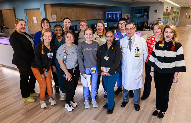 This is a photo of the Tier 1 huddle team inside the pediatric intensive care unit with me and Chief Nursing Officer Shanon Fucik.