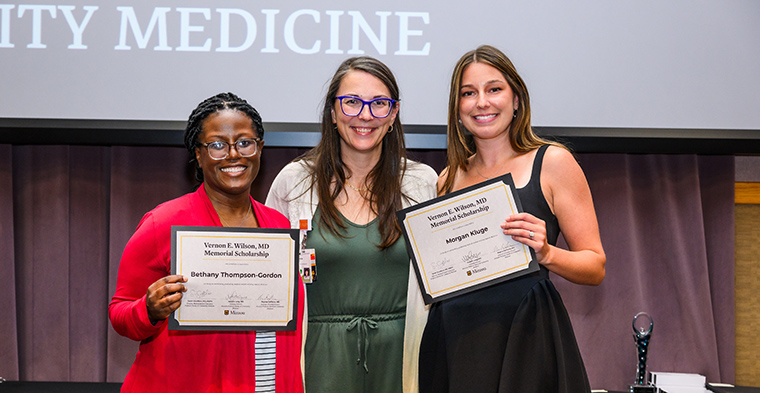  Bethany Thompson-Gordon and Morgan Kluge are presented the Department of Family & Community Medicine Vernon E. Wilson, MD, Memorial Scholarship in Family Medicine.