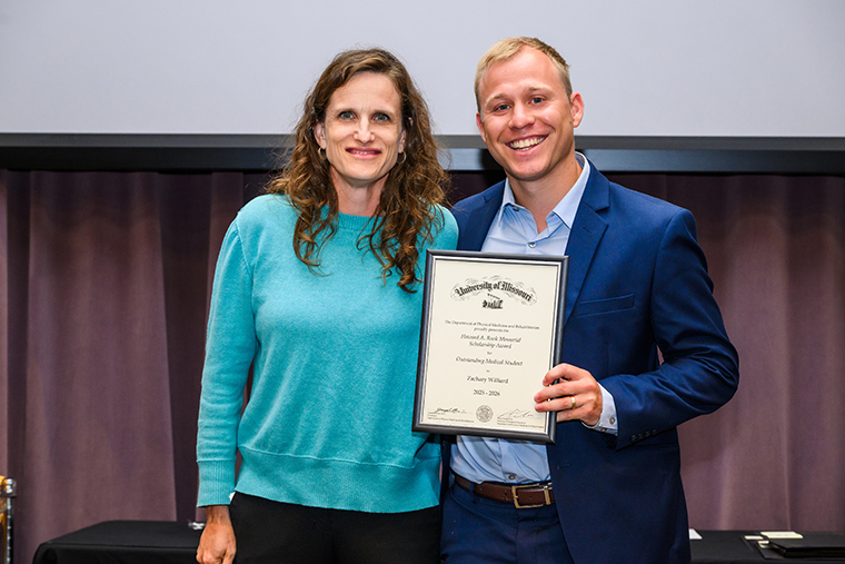 Chrissa McClellan, MD, associate professor of Physical Medicine & Rehabilitation presents Zachary Willard with the PM&R Howard A. Rusk Memorial Scholarship Award.