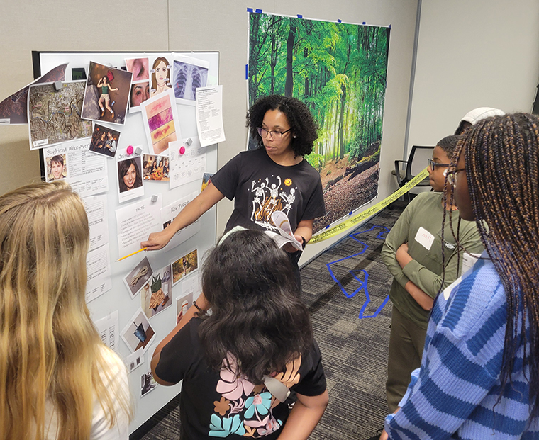 Allison Nesbitt, PhD, leads an interactive station at the CALEB Science Club crime scene investigation workshop.