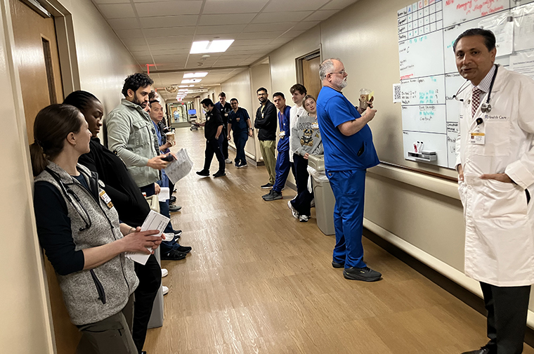  Hasan Naqvi, MD leads the hospitalist huddle.