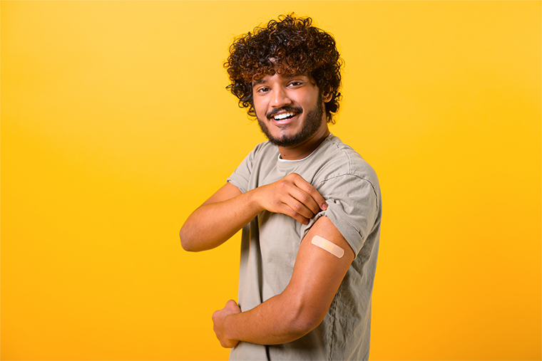 young man showing arm with a bandaid