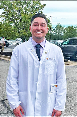 Mullendore donning his MU-branded white coat following the traditional White Coat Ceremony. 