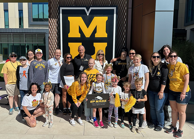 In this photo, patients, their families and our employees pose for a photo with the GP M.A.D.E Foundation, featuring a visit with Gary Pinkel himself. Photo courtesy of Tyler Severance