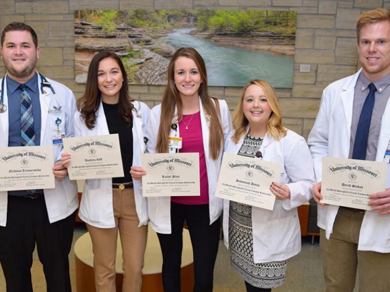 group of students holding up awards