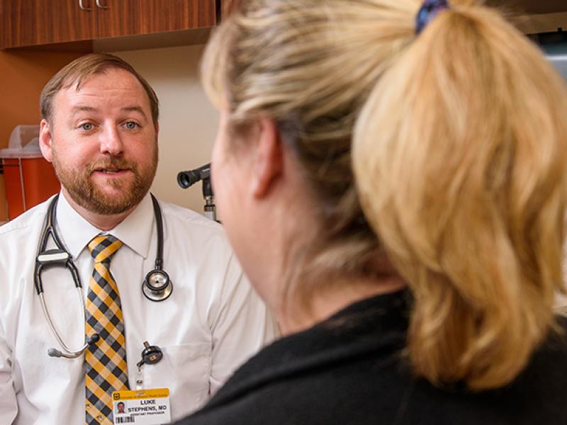 Luke Stephens, MD, visits with a patient at MU Health Care’s family medicine clinic in Ashland.