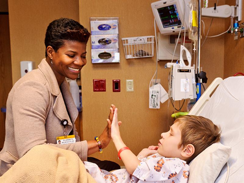 Dr. Elizabeth Malm-Buatsi with patient MU Children's Hospital