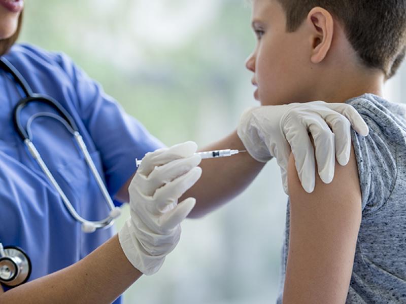 young boy getting an injection in his arm