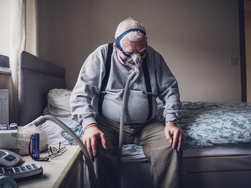 Elderly Man with Medical Breathing Apparatus