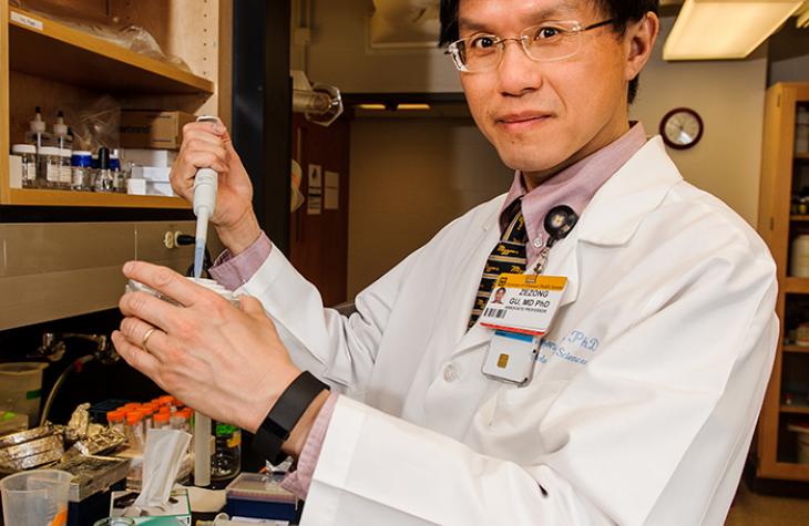 Photo of Dr. Gu in his lab.